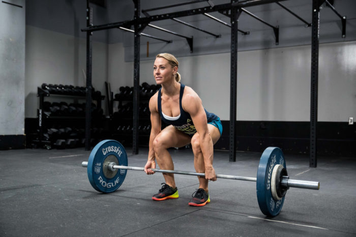 woman performing deadlift in a bigger butt workout